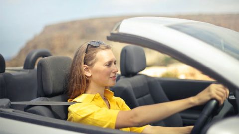 A woman trying to drive a car for Driving Test