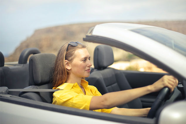 A woman trying to drive a car for Driving Test